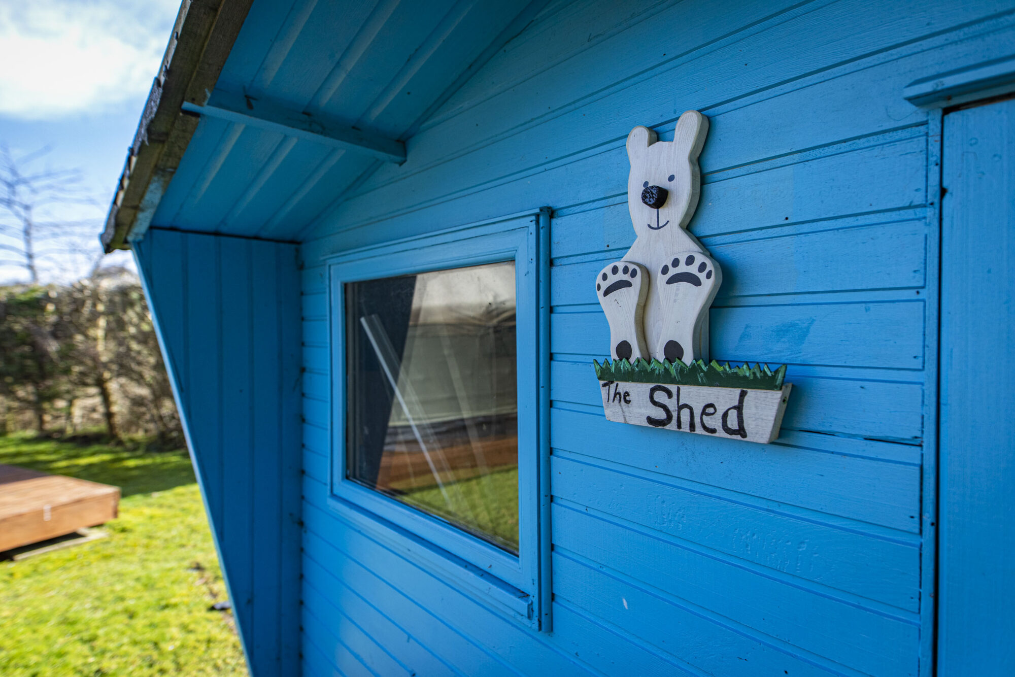 Blue wooden shed in the grounds of Seamab School